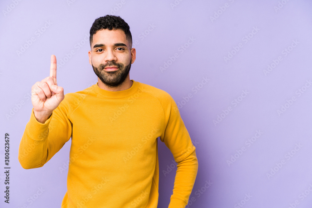 Young mixed race arabic man isolated showing number one with finger. Young mixed race arabic man isolated showing number one with finger.