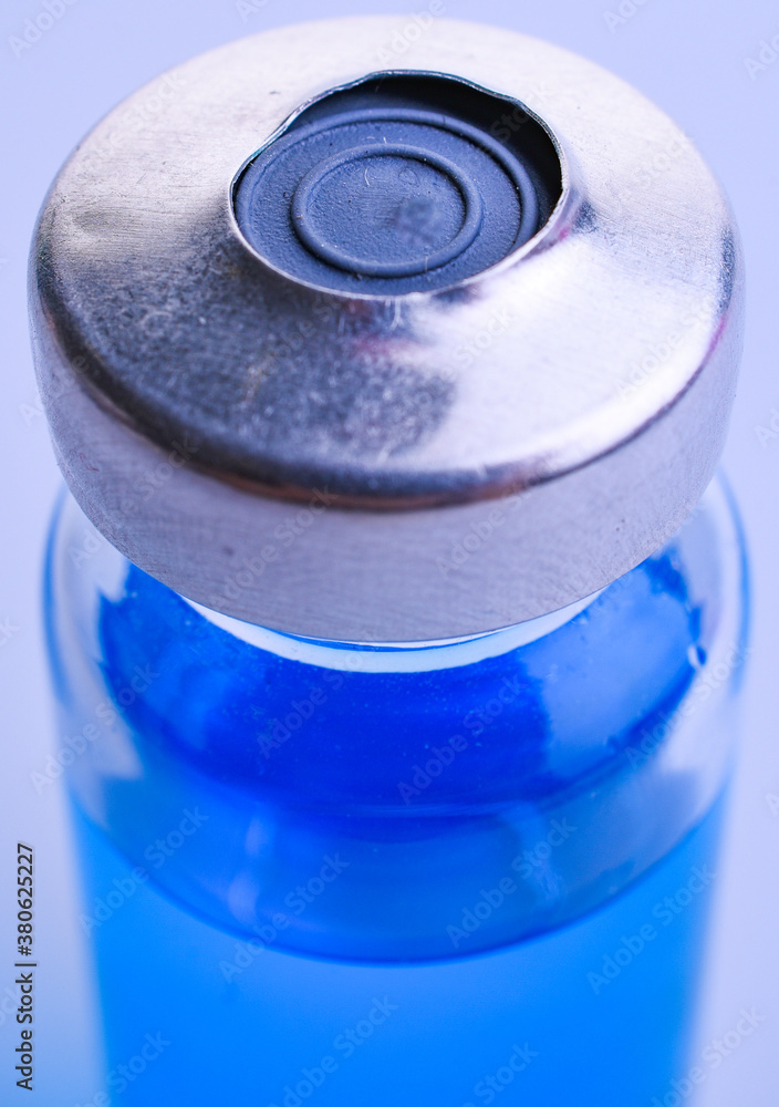Medical blue vial with solution for injection on white background Medical blue vial with solution for injection on white background
