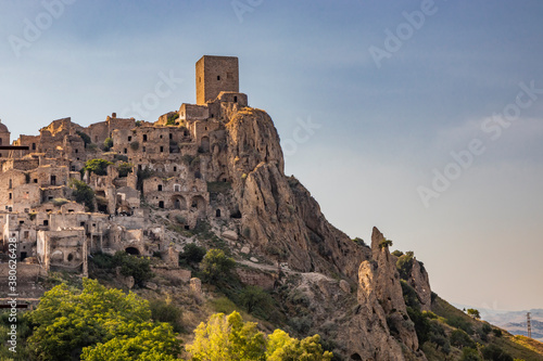 Craco, Matera, Basilicata, Italy. The ghost town destroyed and abandoned following a landslide. View of the remains and ruins of the ancient village built on the top of the hill. Watchtower at the top