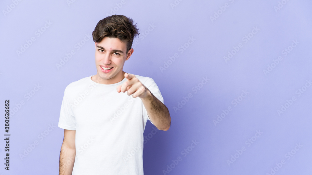 Young caucasian man isolated on purple background pointing to front with fingers. Young caucasian man isolated on purple background pointing to front with fingers.