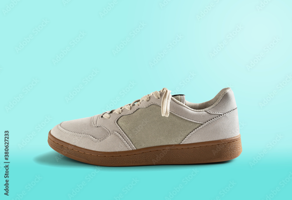 Men's sneaker isolated on blue background. Men's footwear. Men's sneaker isolated on blue background. Men's footwear.