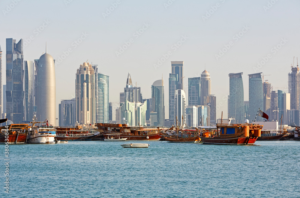 Skyline of modern architecture along the Corniche in Doha with dhows in foreground