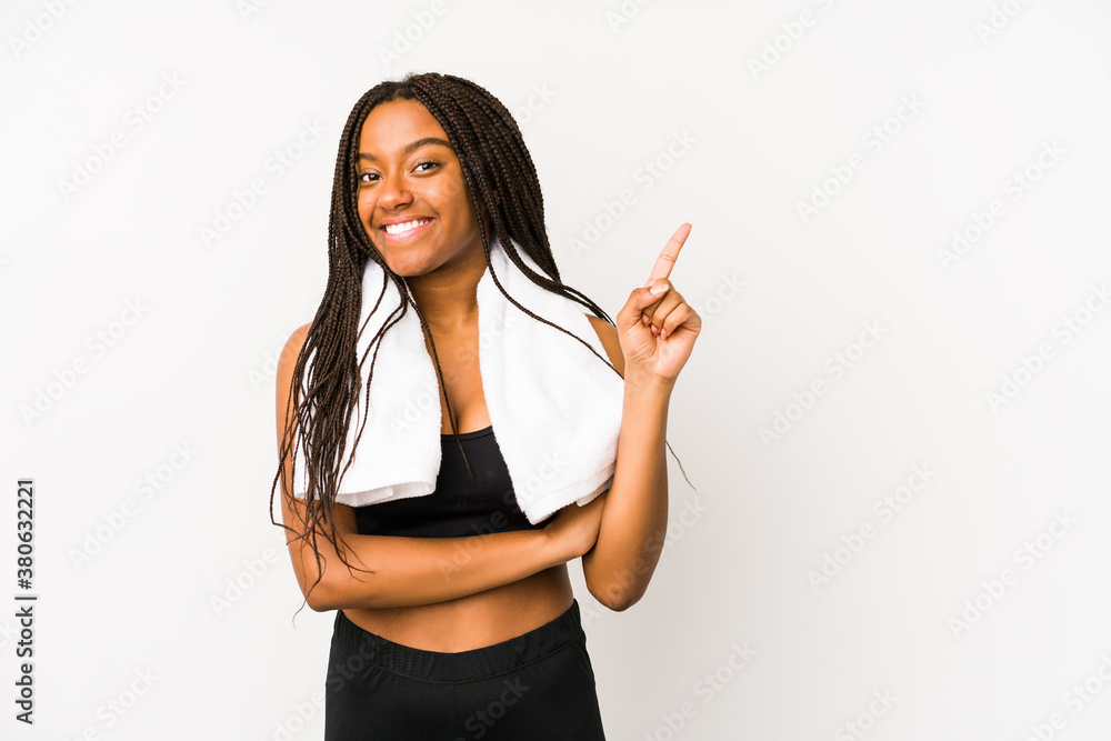 Young african american sport woman isolated smiling cheerfully pointing with forefinger away. Young african american sport woman isolated smiling cheerfully pointing with forefinger away.