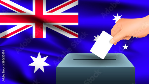 Male hand puts down a white sheet of paper with a mark as a symbol of a ballot paper against the background of the Australia flag. Australia the symbol of elections