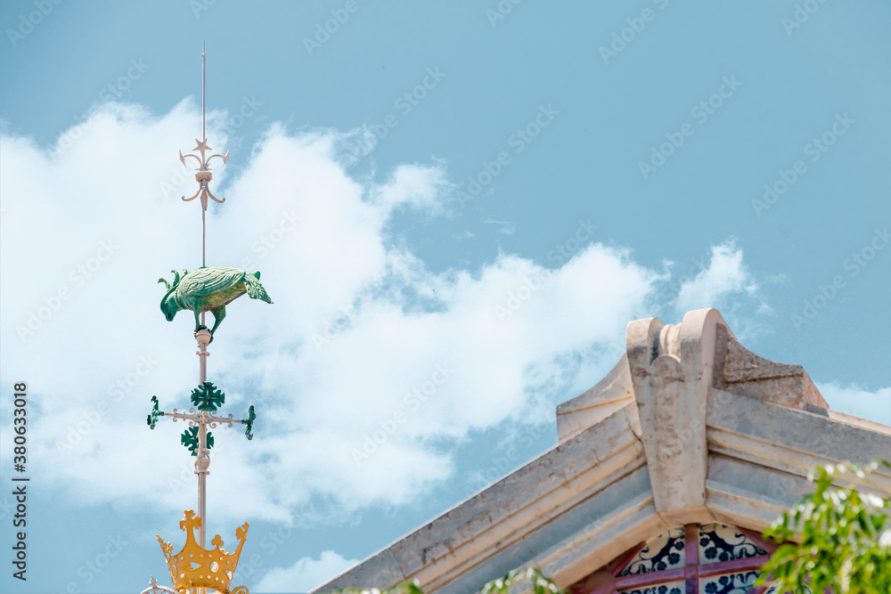 Bird-shaped weathervane (parrot) installed on the roof of the central market of Valencia, Spain Bird-shaped weathervane (parrot) installed on the roof of the central market of Valencia, Spain