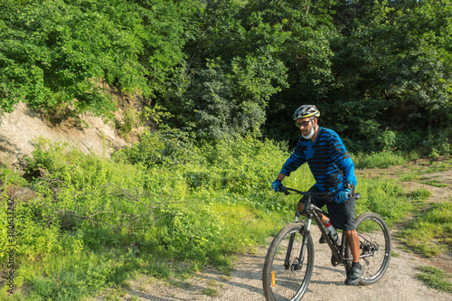 A male mountain biker on a forest trail