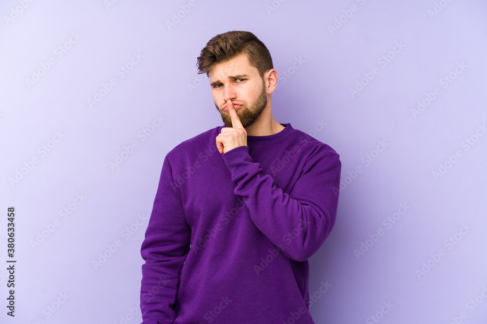 Young caucasian man isolated on purple background thinking and looking up, being reflective, contemplating, having a fantasy. Young caucasian man isolated on purple background thinking and looking up, being reflective, contemplating, having a fantasy.