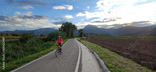woman biking in a road with nice landscape
