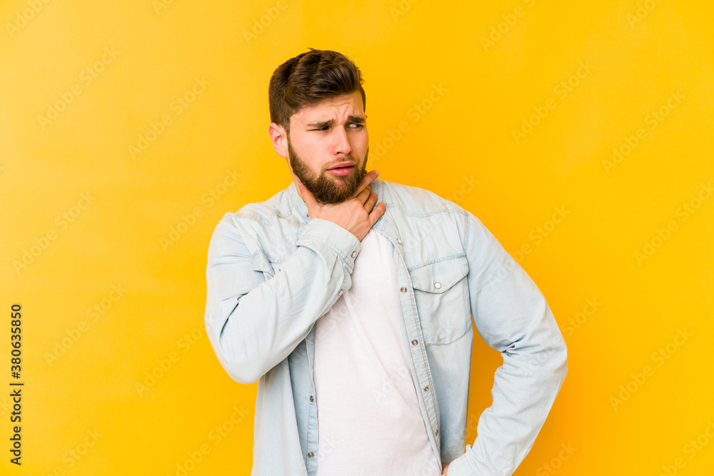 Young caucasian man isolated on yellow background suffers pain in throat due a virus or infection. Young caucasian man isolated on yellow background suffers pain in throat due a virus or infection.