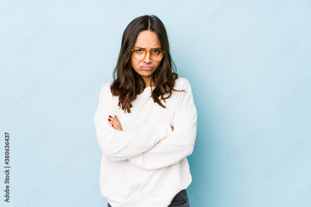 Young mixed race hispanic woman isolated frowning face in displeasure, keeps arms folded. Young mixed race hispanic woman isolated frowning face in displeasure, keeps arms folded.