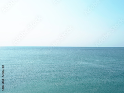 Blue ocean. Small waves. A direct horizon and an immense distance. Clear, blue sky. There is not a single cloud. High quality photo