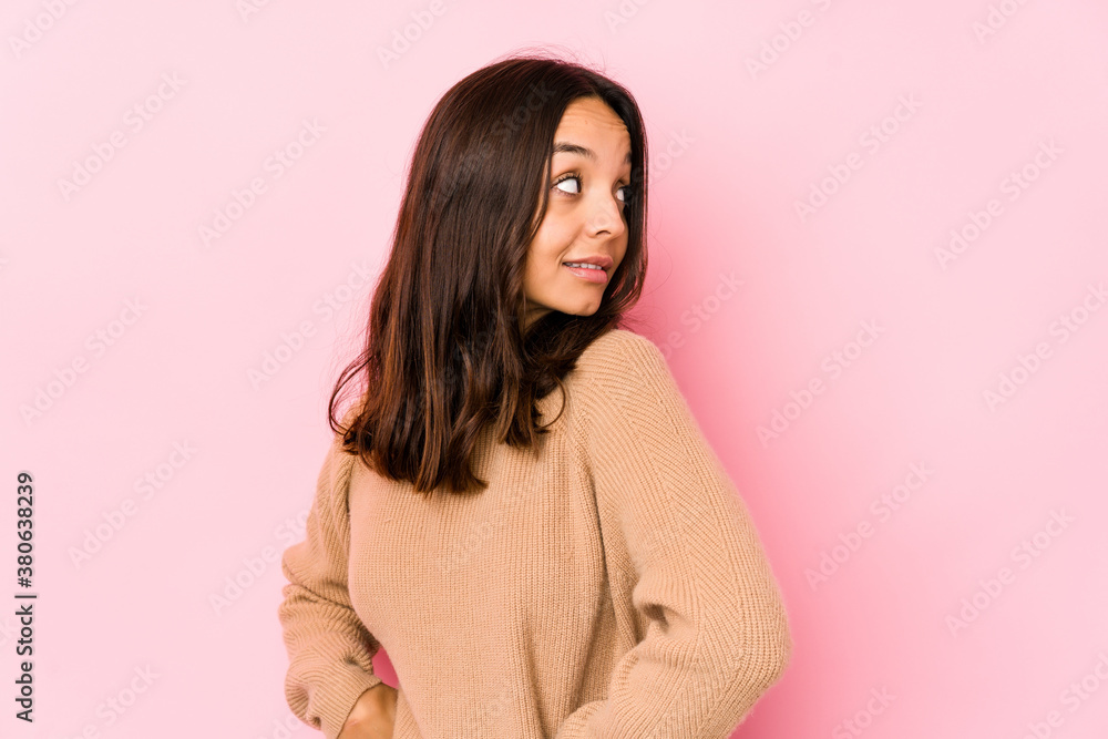 Young mixed race hispanic woman isolated looks aside smiling, cheerful and pleasant. Young mixed race hispanic woman isolated looks aside smiling, cheerful and pleasant.