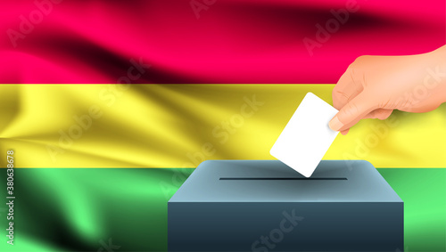 Male hand puts down a white sheet of paper with a mark as a symbol of a ballot paper against the background of the Bolivia flag. Bolivia the symbol of elections