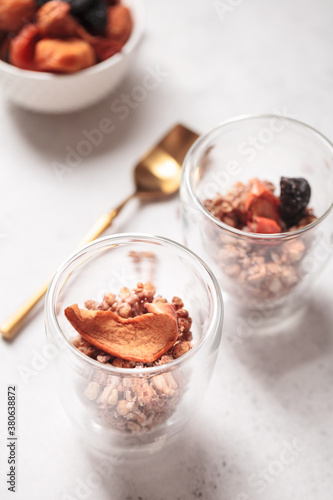 Breakfast with granola. Granola with Chia and apricot. Light background. Healthy breakfast. Wholesome breakfast