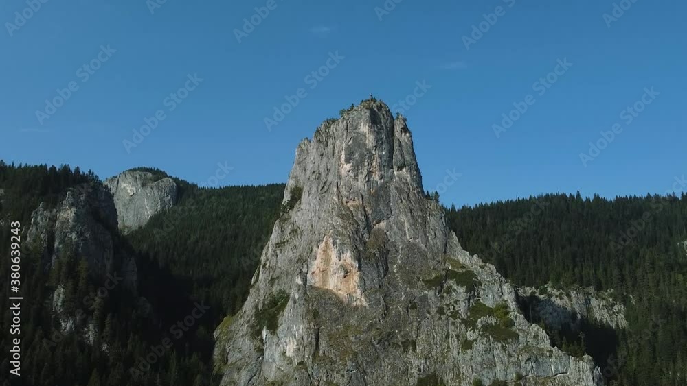 The peak of a mountain and a cross above. The peak of a mountain and a cross above.