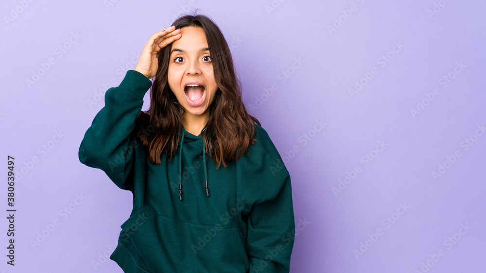 Young mixed race hispanic woman isolated shouts loud, keeps eyes opened and hands tense. Young mixed race hispanic woman isolated shouts loud, keeps eyes opened and hands tense.