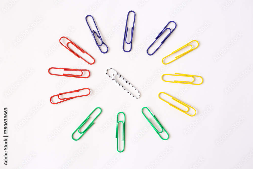 Colored paper clips close-up on a white background Colored paper clips close-up on a white background