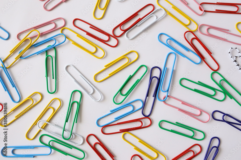 Colored paper clips close-up on a white background Colored paper clips close-up on a white background