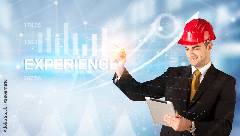 Young businessman with helmet drawing EXPERIENCE inscription, modern business technology concept Young businessman with helmet drawing EXPERIENCE inscription, modern business technology concept
