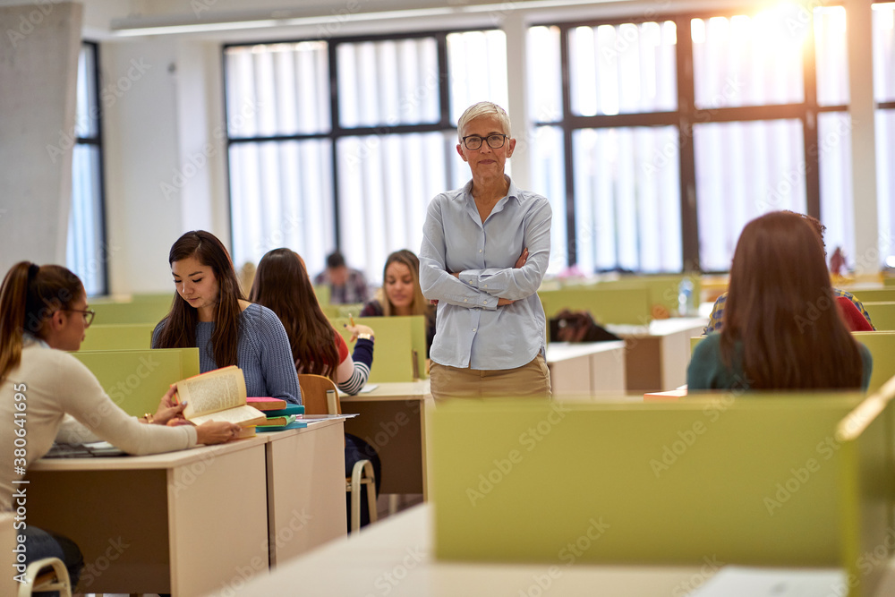 Female professor posing for a photo in the classroom Female professor posing for a photo in the classroom