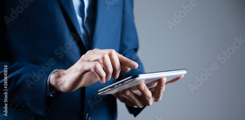 businessman holds tablet in hand © S...