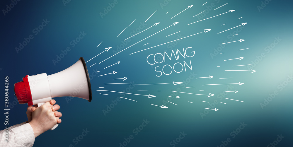 Young girl screaming to megaphone with COMING SOON inscription, shopping concept Young girl screaming to megaphone with COMING SOON inscription, shopping concept