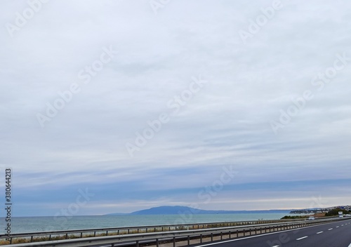 Blue sky with turquaz water on double highway