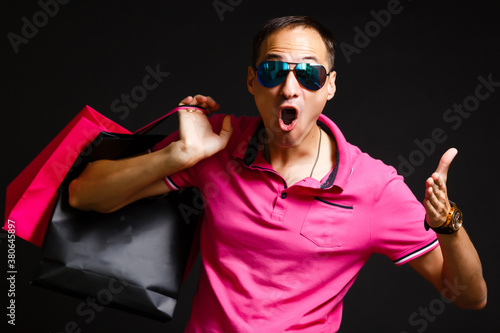 young caucasian man is holding shopping bags