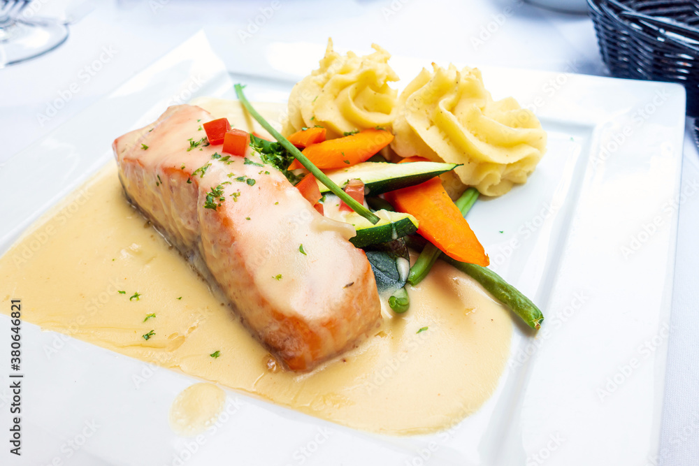 grilled salmon and lemon - french cuisine dish with tomato and salmon grilled salmon and lemon - french cuisine dish with tomato and salmon