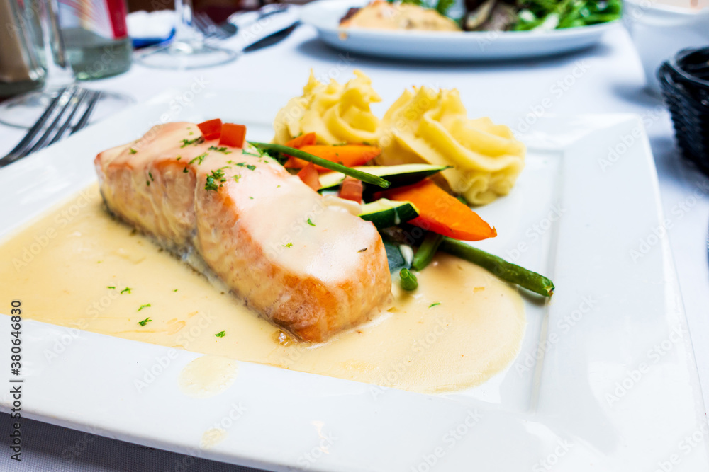 grilled salmon and lemon - french cuisine dish with tomato and salmon