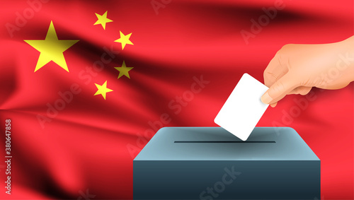 Male hand puts down a white sheet of paper with a mark as a symbol of a ballot paper against the background of the China flag. China the symbol of elections