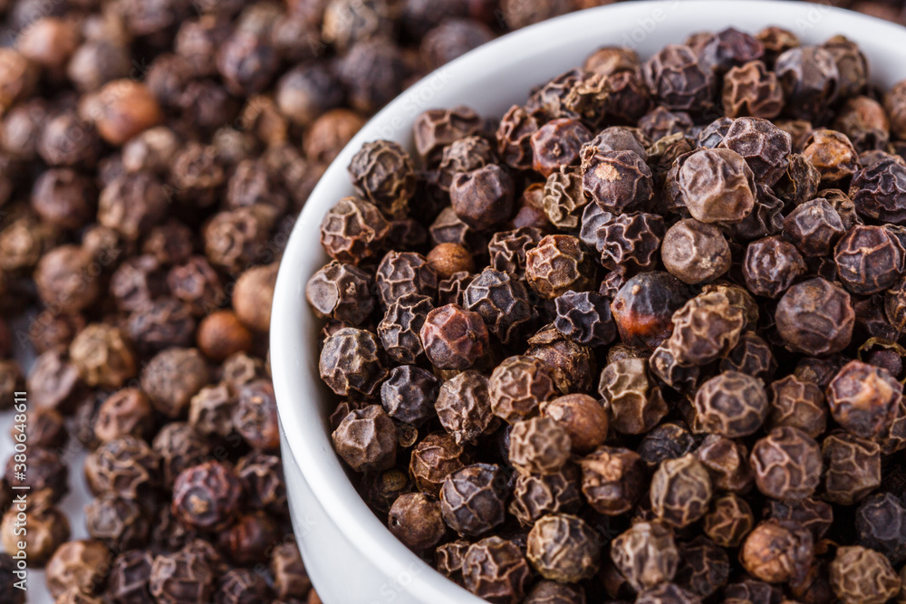 fragrant black pepper on white acrylic background fragrant black pepper on white acrylic background