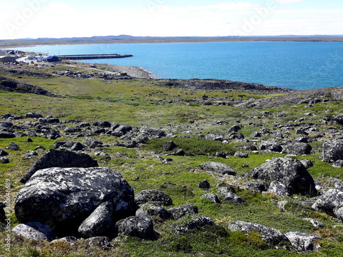 Landscape by the water in Aupaluk showing the blue sea and rocks in Nunavik