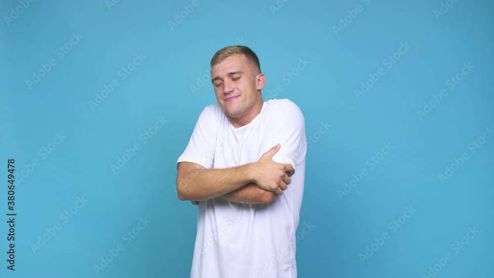 Young caucasian man hugs, smiling carefree and happy Young caucasian man hugs, smiling carefree and happy