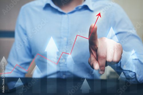 Businessman finger pointing arrow graph. Business development, profit and growing growth plan. 