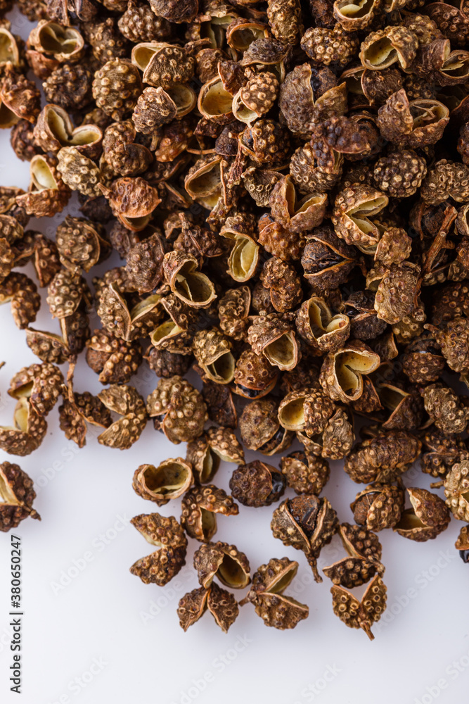Obraz premium fragrant Sichuan pepper on white acrylic background