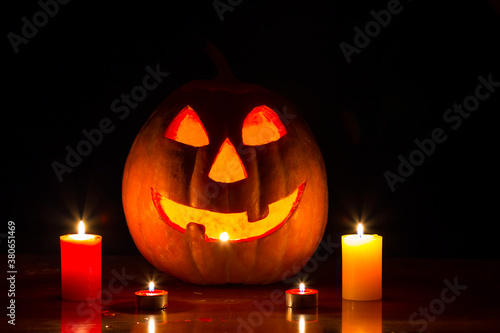 halloween mystic night scene, jack o lantern pumpkin with candle on the table