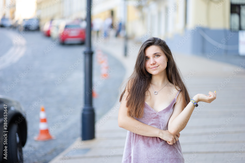 Portrait of a young woman with a lovely smile in a velor summer dress. Portrait of a young woman with a lovely smile in a velor summer dress.