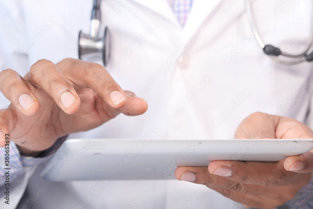 doctor in white coat is using a digital tablet doctor in white coat is using a digital tablet