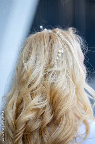 Hair ornament close-up. Blonde hair. Blonde woman with a wreath in her hair.