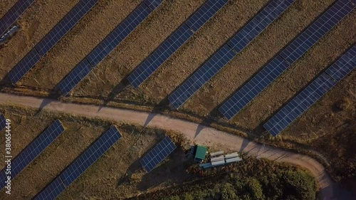 Birds Eye View of Sunny Solar Panels in Field - 4K Aerial Footage photo