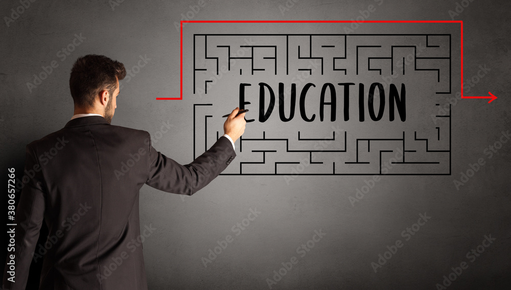 businessman drawing maze with EDUCATION inscription, business education concept businessman drawing maze with EDUCATION inscription, business education concept