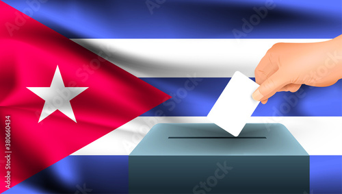 Male hand puts down a white sheet of paper with a mark as a symbol of a ballot paper against the background of the Cuba flag. Cuba the symbol of elections