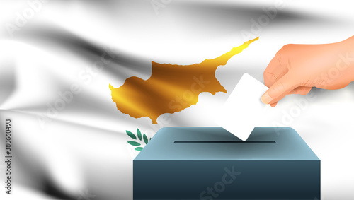 Male hand puts down a white sheet of paper with a mark as a symbol of a ballot paper against the background of the Cyprus flag. Cyprus the symbol of elections
