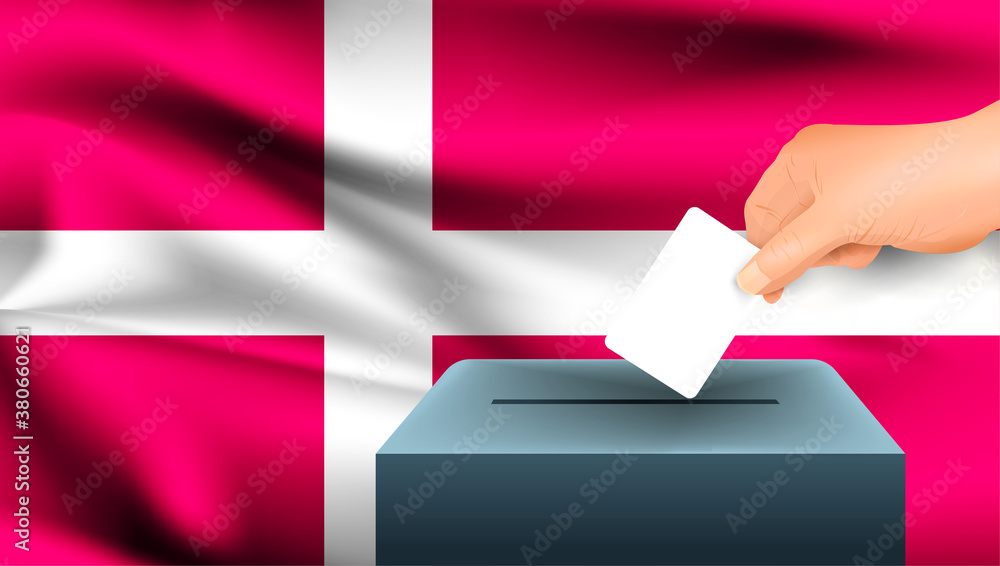 Male hand puts down a white sheet of paper with a mark as a symbol of a ballot paper against the background of the Denmark flag. Denmark the symbol of elections Male hand puts down a white sheet of paper with a mark as a symbol of a ballot paper against the background of the Denmark flag. Denmark the symbol of elections
