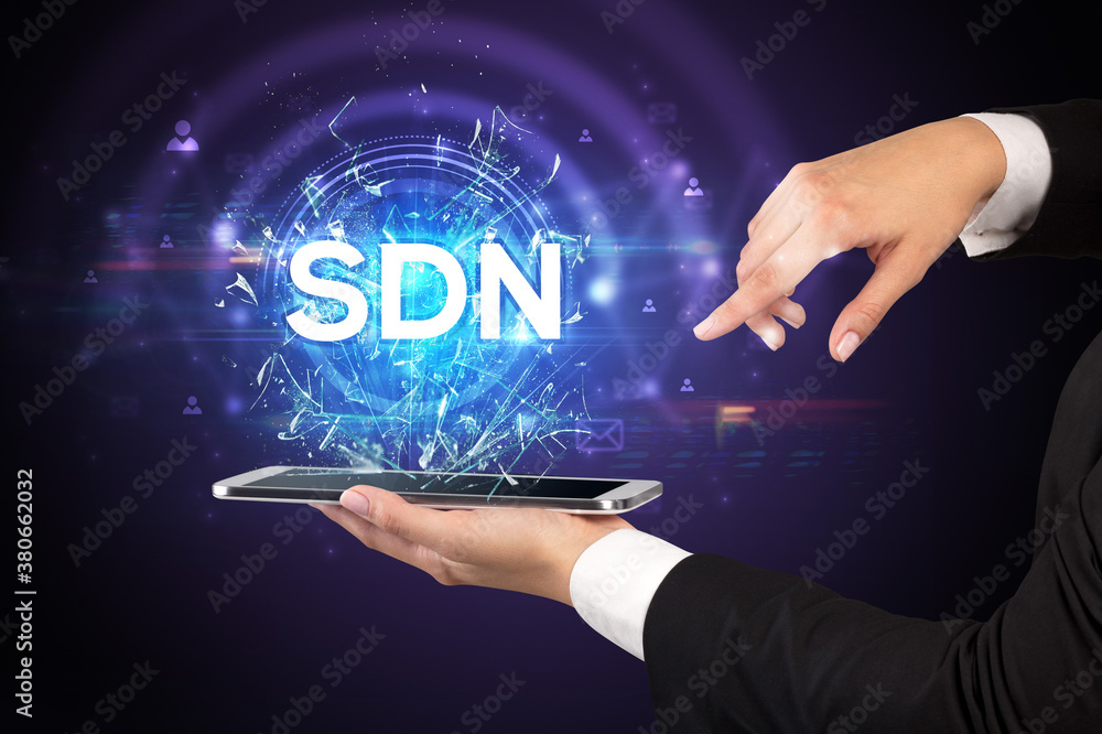 Close-up of a touchscreen with SDN abbreviation, modern technology concept Close-up of a touchscreen with SDN abbreviation, modern technology concept