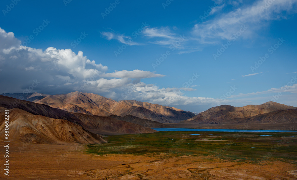 Central Asia. Tajikistan. A picturesque lake with swampy shores in a deserted mountain valley along the Pamir highway.