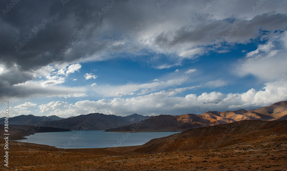 Central Asia. Tajikistan. A picturesque lake with swampy shores in a deserted mountain valley along the Pamir highway.