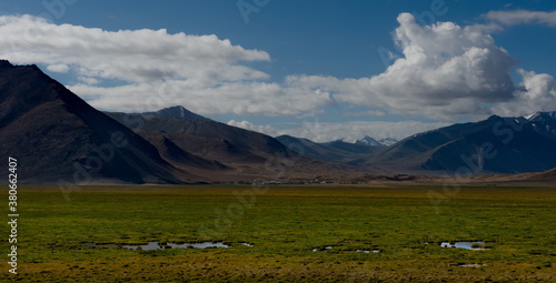 Central Asia. Tajikistan. A picturesque lake with swampy shores in a deserted mountain valley along the Pamir highway.