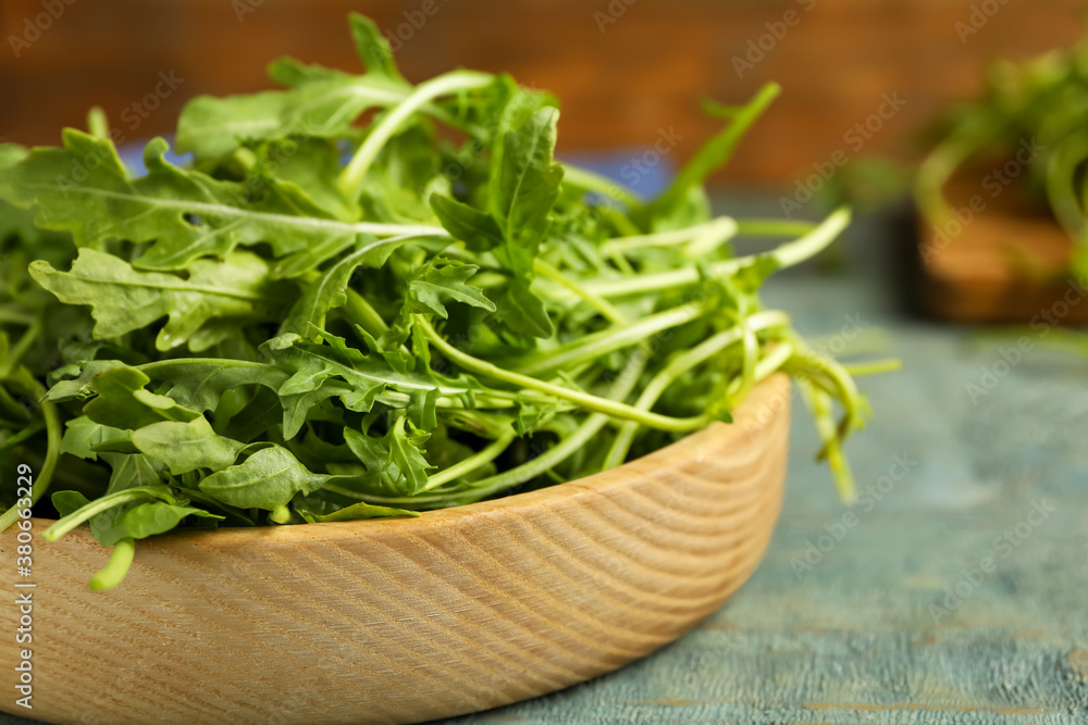 Fresh arugula on blue wooden table, closeup